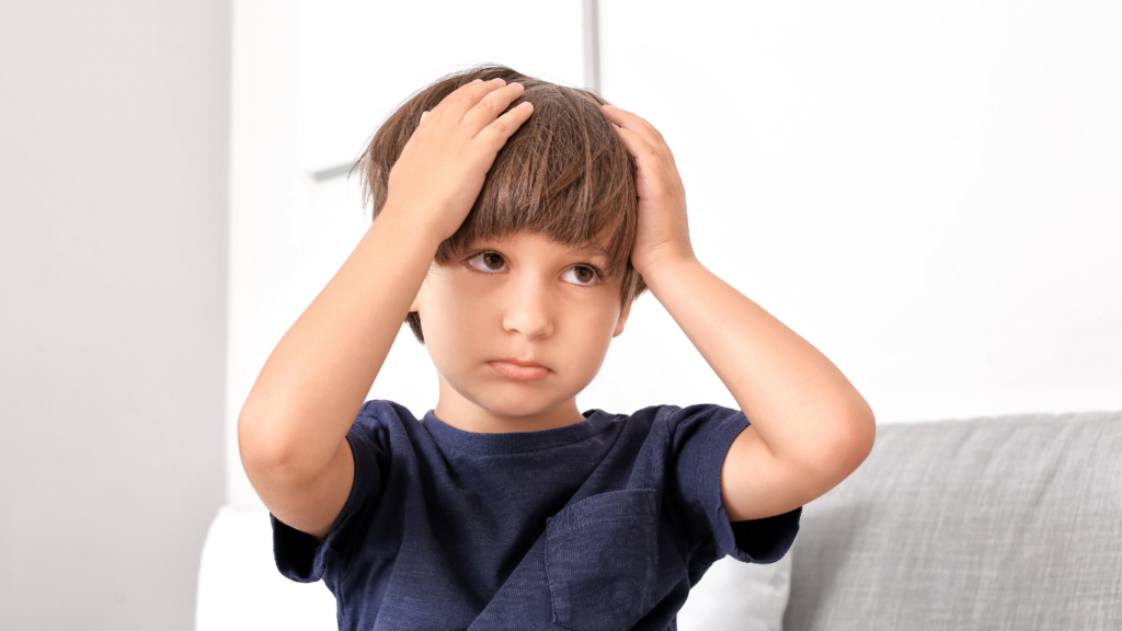 Boy holding his head