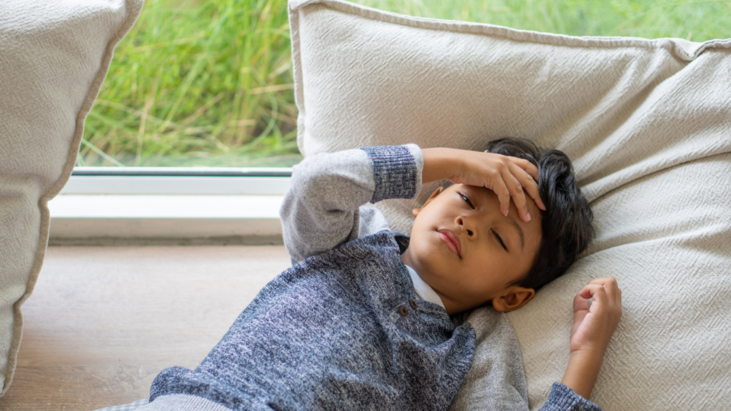 Boy lying with migraine