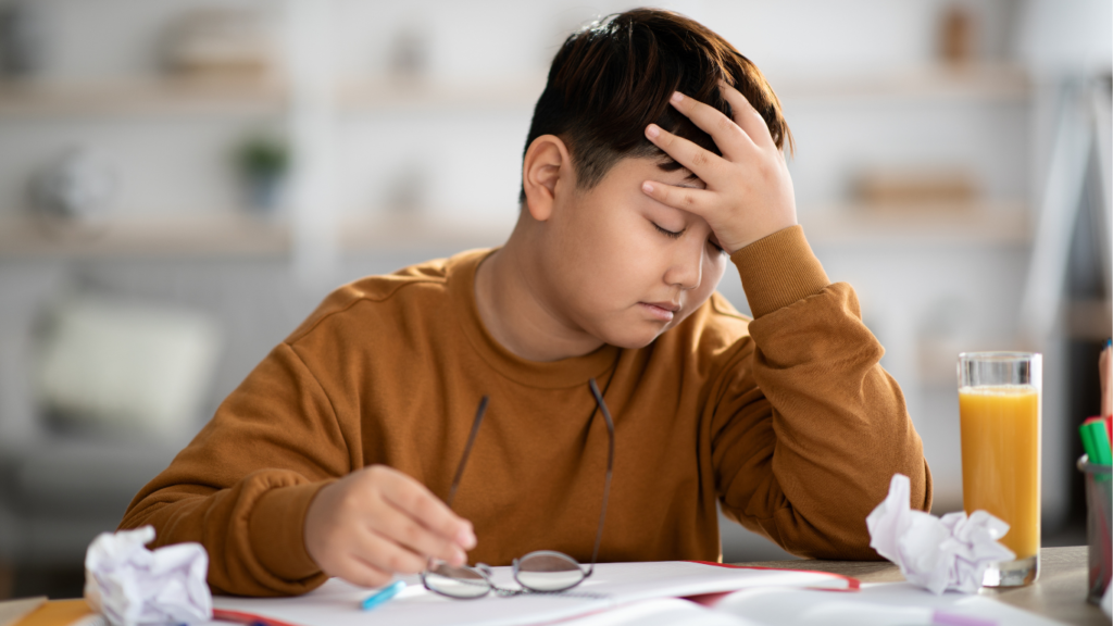 Boy trying to deal with migraine