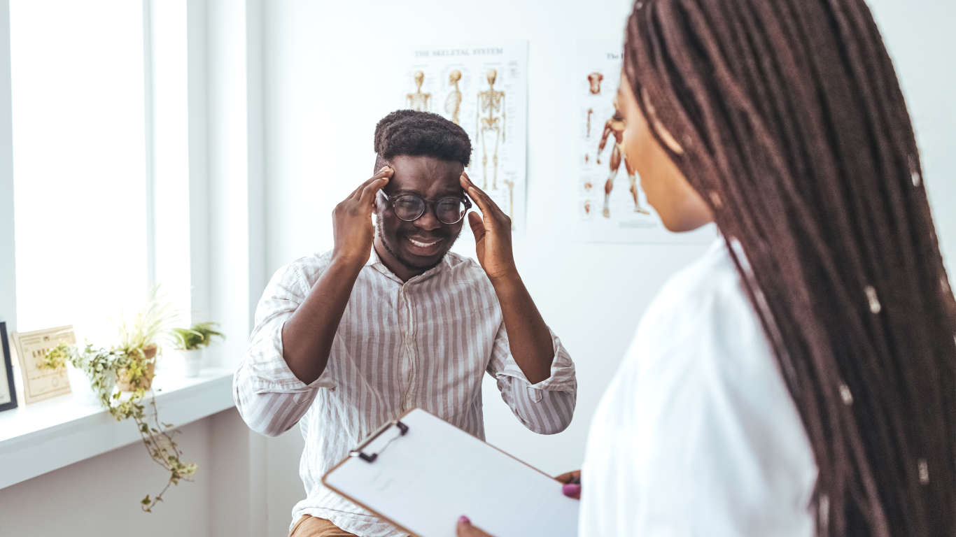 Man with migraine at the doctor