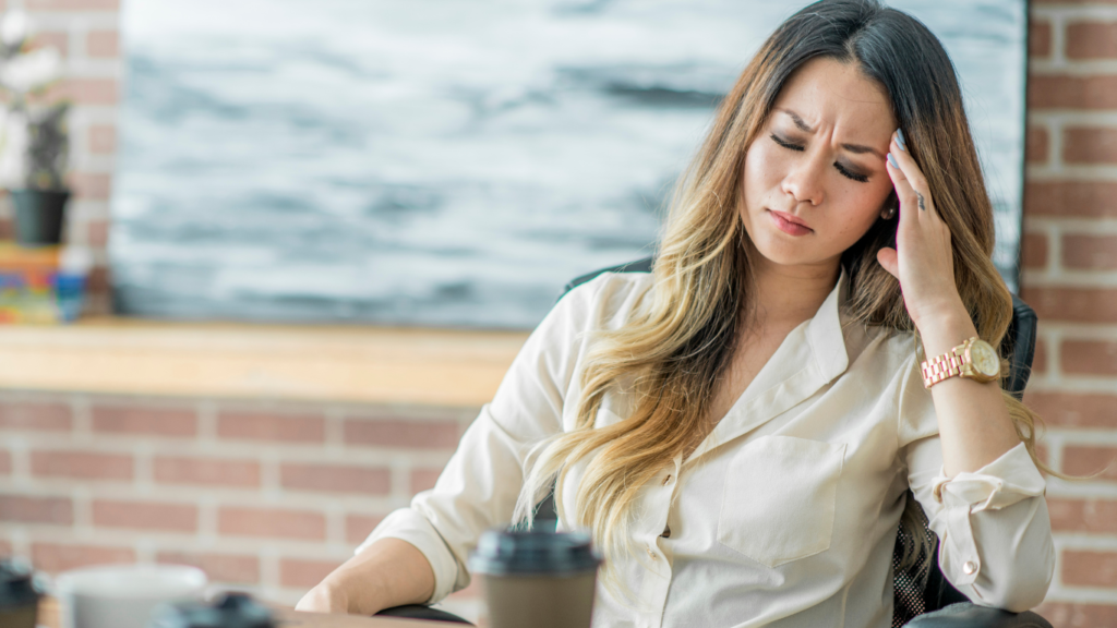 Woman sitting with migraine