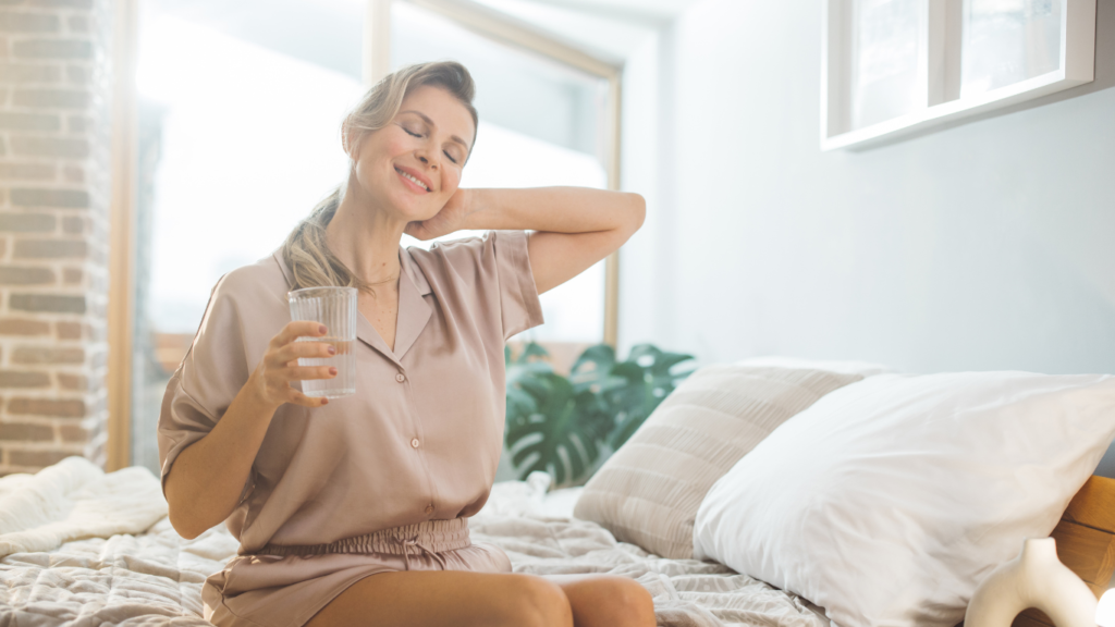 Woman with a glass of water and a migraine